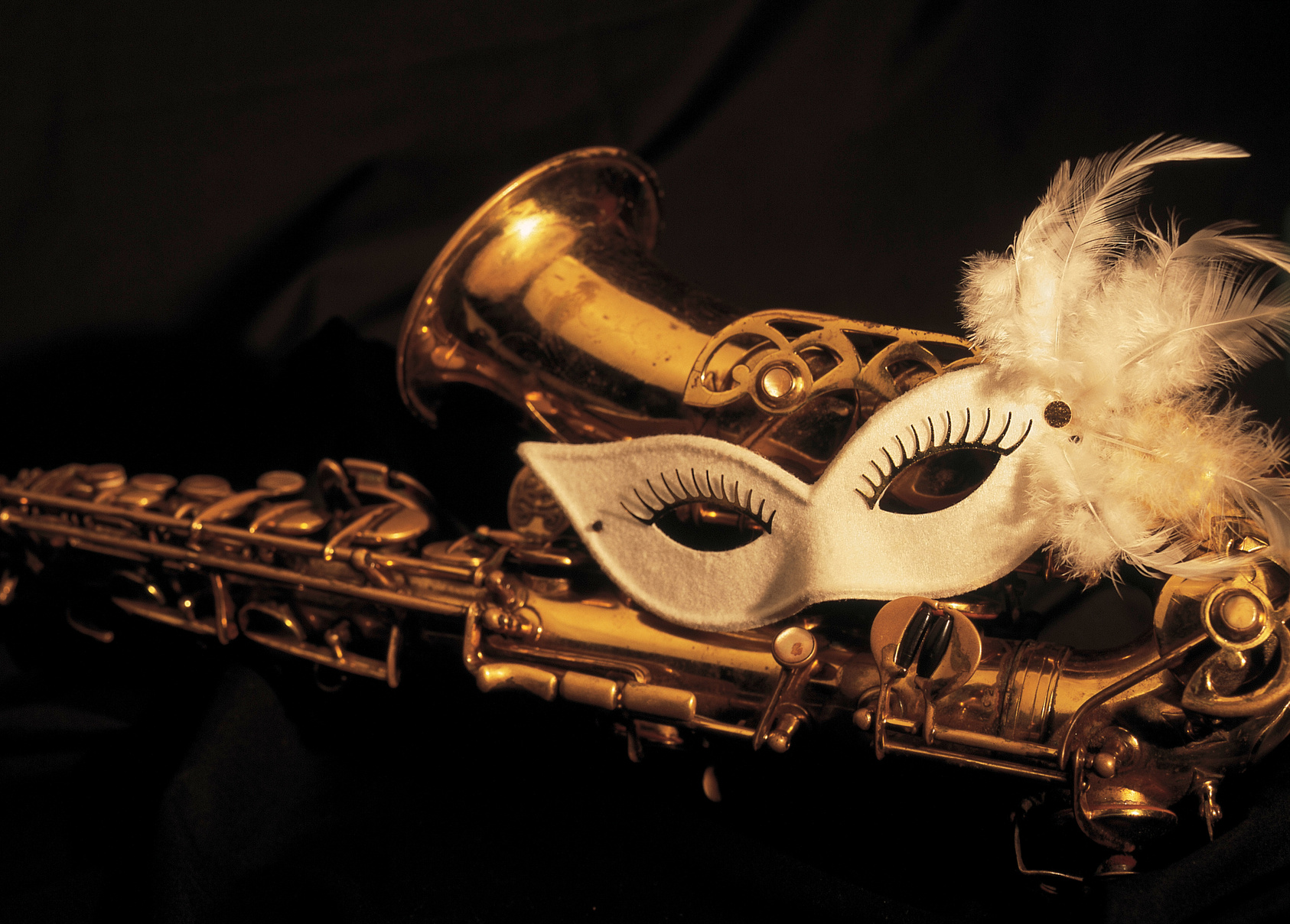 brass saxophone with masquerade mask